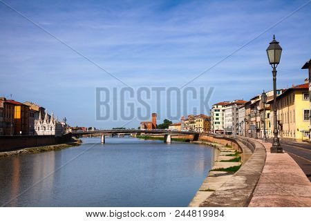 Pisa cityscape with medieval waterfront buldings and Pisan Gothic Santa Maria della Spina church on Arno River embankment, Tuscany, Italy