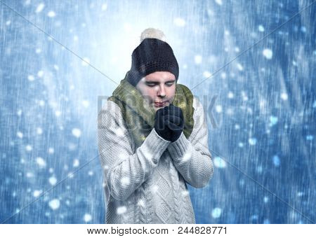 Handsome young boy shivering and trembling at snowstorm concept
