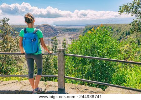 Hawaii hiking travel tourist hiker girl looking at view of Kilauea Iki crater lava field lake in Big Island, Hawaii. United states of America summer vacation popular attraction.