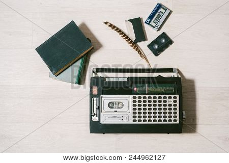 Old Cassette Tape Recorder, Books And Feather. Top View. Layflat