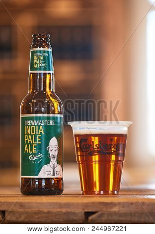 COPENHAGEN, DENMARK - MAY 9, 2018: Brewmasters India Pale Ale on a bar table poured in a cup