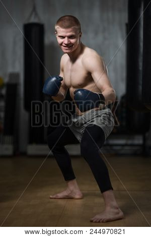 Young Boxer In A Fighting Stand In The Training Hall