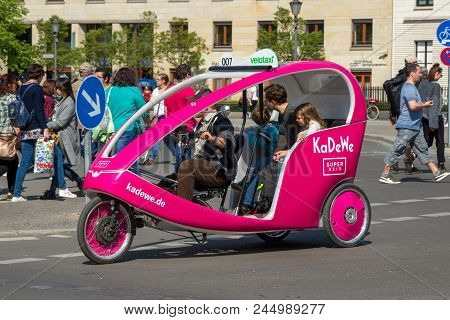 Berlin, Germany - Apr 28, 2018: Velotaxi Bike Taxi With Customers Cycling Through The Streets Of Ber