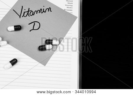 Writing  Vitamin D On Memo Post Reminder And Medicines, Pills.  Writing Vitamin D On Sticky Paper.