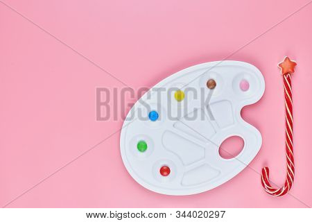 Art Of Sweetmeats Concept, Copy Space. Sweet Candy In Paint Palette On Pink Background. Love To Colo