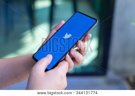Chiang Mai, Thailand - Oct.18,2019: Woman Holding Xiaomi Mi Mix 3 With Twitter App On The Screen.twi