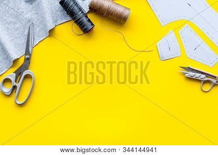 Sewing Wokrshop. Textile, Pattern, Scissors, Thread On Yellow Background Top-down Copy Space