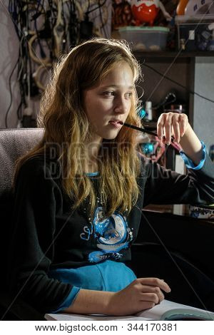 image of a girl doing school homework in the evening