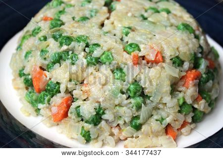 Fried Rice With Vegetables On Blue Plate Close Up View. Asian Cuisine Concept