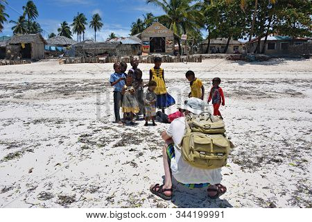 Pingwe, Zanzibar - October 6, 2019: Professional Man Photographer Takes A Picture Of Group The Afric