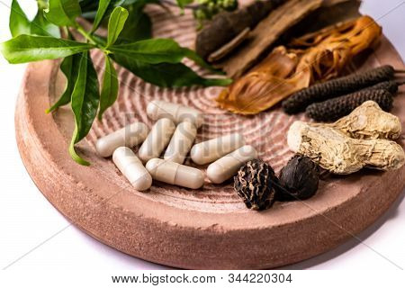 Herbal Medicine Concept. Front View Macro Of Spices, Capsules And Herbs On A Stone