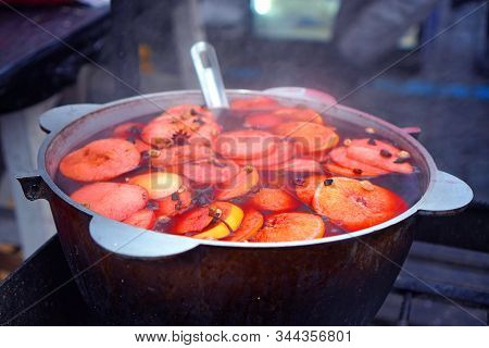 Mulled Wine Is Preparing In A Casserole Pot On The Street