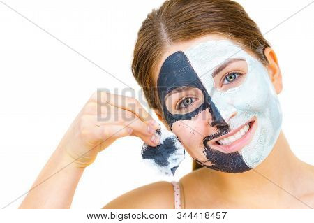 Woman With Clay Carbo Black Mask On One Half Face And White Mud On Second Half. Girl Removing Cosmet