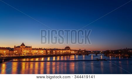 View Of River Moldau And National Theatre At Night In Prague.