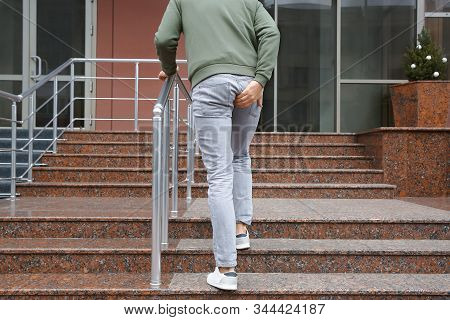 Man Suffering From Hemorrhoid Pain Outdoors, Back View