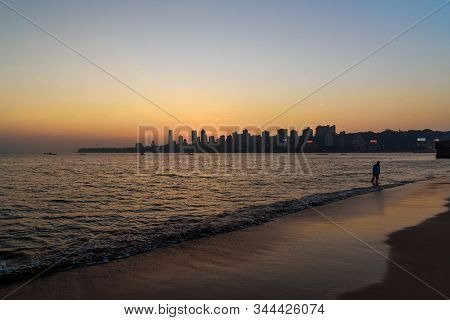Sunset On Chowpatty Beach. View Of Malabar Hill In Mumbai. India