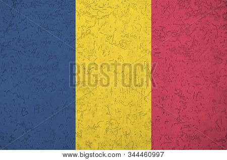 Chad Flag Depicted In Bright Paint Colors On Old Relief Plastering Wall. Textured Banner On Rough Ba