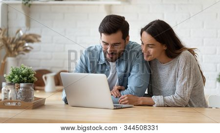 Happy Young Mixed Race Married Spouse Making Purchases Online.