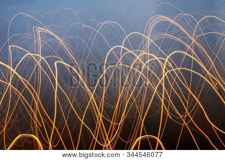 Creative Photography With Unusual Pattern Of Dancing Light Or Neon In Chaotic Lines On Abstract Back