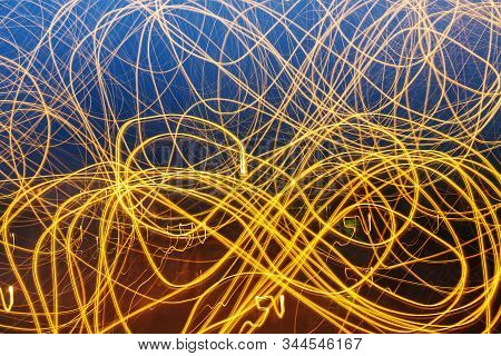 Creative Photography With Unusual Pattern Of Dancing Light Or Neon In Chaotic Lines On Abstract Back