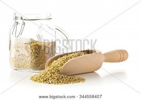 Heap Of Uncooked, Raw Freekeh Or Firik, Roasted Wheat Grain, In Wooden Scoop And Glass Storage Jar O