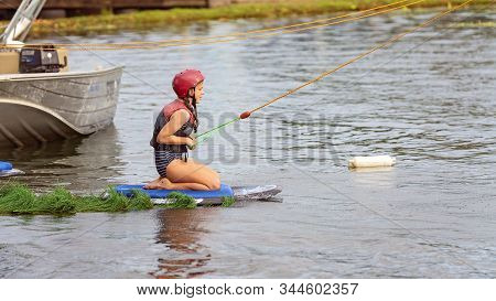Mackay, Queensland, Australia - January 2020: A Child Wearing A Safety Helmet And Life Jacket Enjoyi