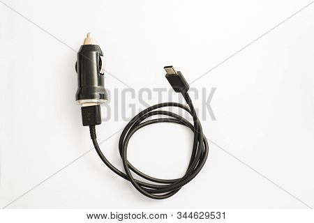 The Black Car Charger With Usb Output Connection Cable. A Photo Taken On A Black Car Charger With Us