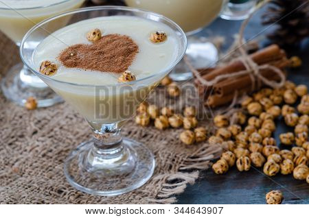 Traditional Turkish Drink; Boza With Cinnamon Sticks And Chickpea