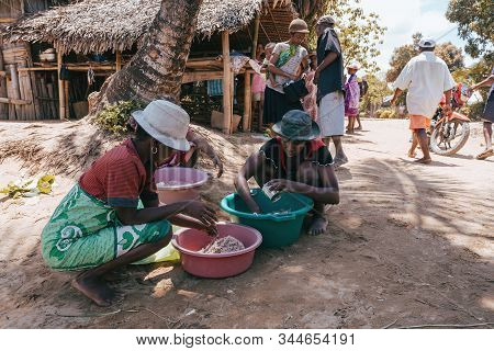 Maroantsetra, Madagascar October 20.2016: Native Woman Sort Catch On Village Common After Sea Fishin