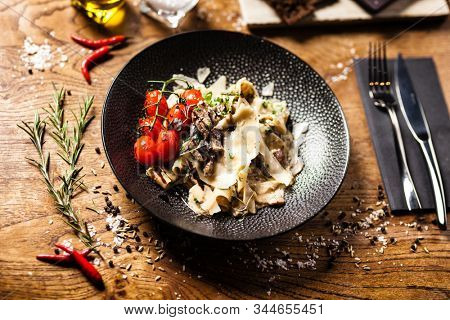 Black Angus pappardelle pasta with beef, champignon and parmegano cheese