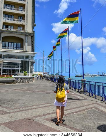 Port Louis, Mauritius - Jan 4, 2017. A Woman Walking On Caudan Waterfront Of Port Louis, Mauritius. 