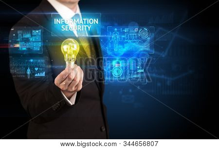 Businessman holding lightbulb with INFORMATION SECURITY inscription, online security idea concept