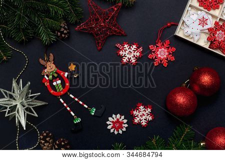 Christmas Toys And Decorations With Balls, Stars, Bells And Snowflakes On A Black Background