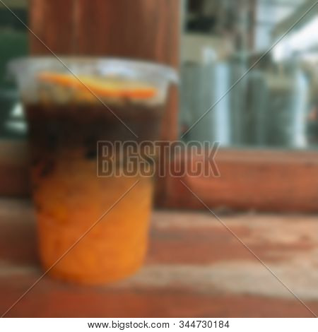 Blur Background Of A Glass Of Espresso Shot Mixed With Craft Soda And Orange Juice