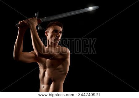 Crop Of Young Fit Strong Warrior With Cold Weapon Looking Away. Muscular Half Naked Athlete Showing 