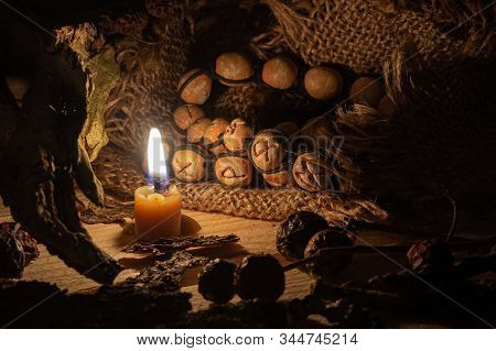 In The Center, Fire Candles And Clay Runes Lie On A Beige Fabric. Runic Circle. The Concept Of Magic