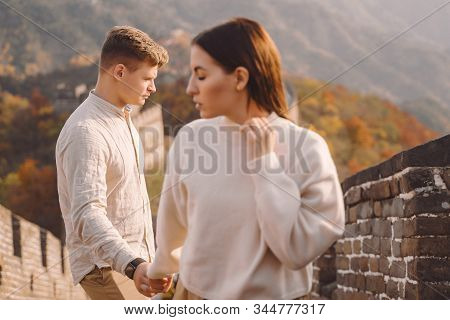 Beautiful Young Couple Holding Hands And Showing Affection At The Great Wall Of China