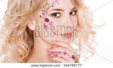 Cosmetics And Manicure. Close-up Portrait Of Attractive Woman With Dry Flowers On Her Face, Pastel C