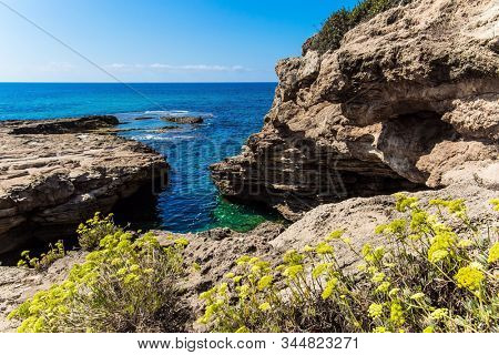 Rocky bay near chalk mountain Rosh a Nikra - geological formation in northern Israel. The color of sea water changes from azure to dark blue. The concept of active, eco and photo tourism