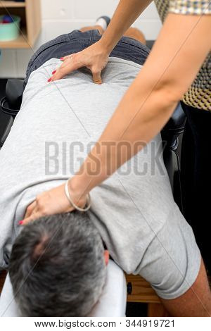 Man Having Chiropractic Back Adjustment. Physioterapy, Osteopathy, Alternative Medicine Pain Relief 
