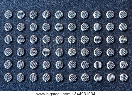 Tactile Gray Tiles On The Sidewalk. Close Up. Metal Tactile Indicators