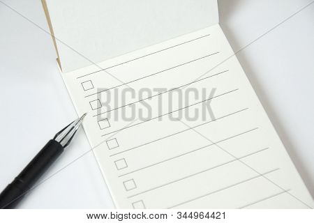Blank To Do List Planner With Checklist And Black Pen On White Background, Close Up View