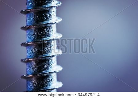 Part of screw with thread on grey background