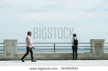 Baku, Azerbaijan - May 2, 2019: Tourist Woman Admiring Polluted Caspian Sea From The Iconic Seaside 