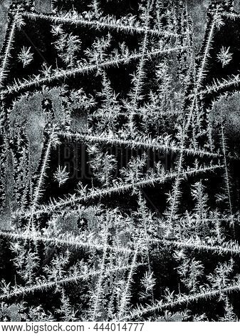 Frostwork Pattern Ice Crystals On Black Background. Dark Surface With Abstract Ice Structure Makes T