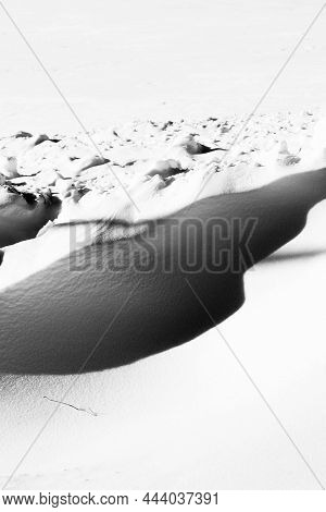 Close-up Of Snow Drifts And Natural Shadows In Black And White, Vertical