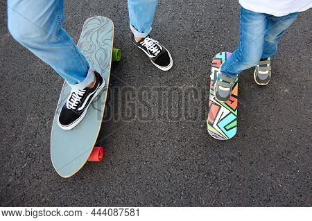 Child And A Teenager Play Skateboard Racing. Interesting Games For Children. Learning To Ride Skateb