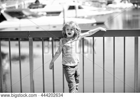 Vacation Time. Happy Kid Stand At Quay Railing. Summer Vacation. Summertime. Vacay Mode