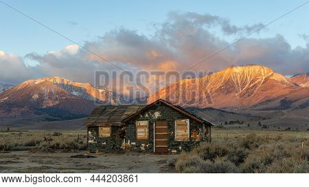 Abandoned Old House At Sunrise In Front Of The California Sierra Nevada Mountains
