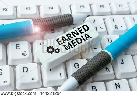 Text Sign Showing Earned Media. Business Idea Publicity Gained Through Promotional Efforts By Multim